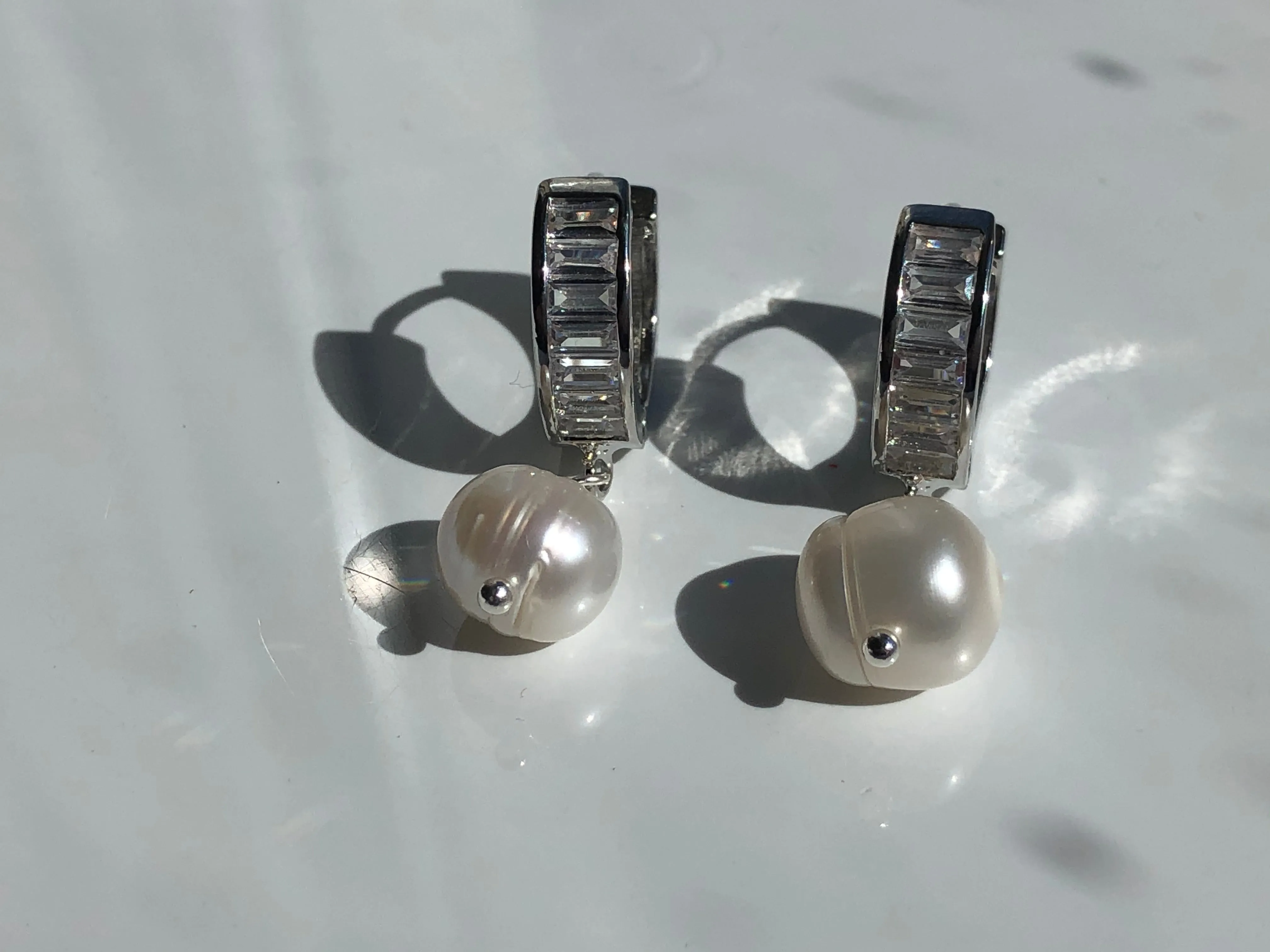 Earrings: Large single Pearl drop earrings on a baguette encrusted hoop - classic